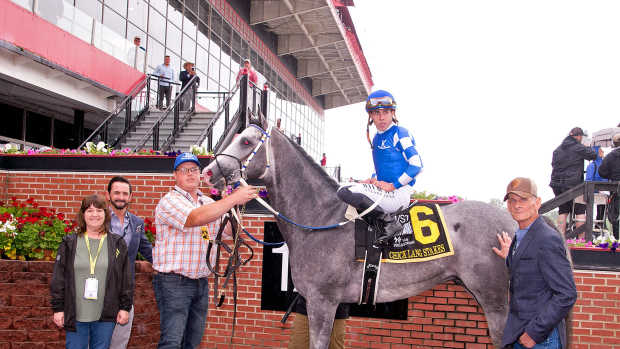 Trainer Brett Creighton, right, in the winner's circle for his first graded stakes win with Frost Free in the G3 Chick Lang at Pimlico