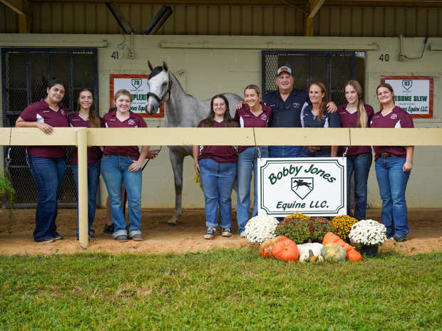 Bobby and Lori Jones (black shirts) with students from the North Marion High School Equine Program with Hip 186 at the OBS October Yearling sale